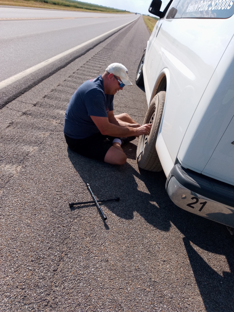 Mr. Kempenich changing a flat tire